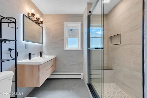 a bathroom with a sink mirror bathtub and shower