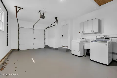 a view of a storage & utility room with two washing machine