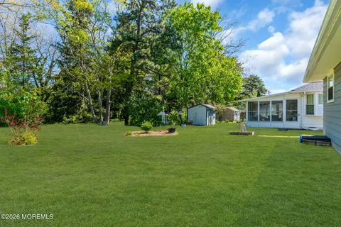 a view of a house with a yard balcony and sitting area