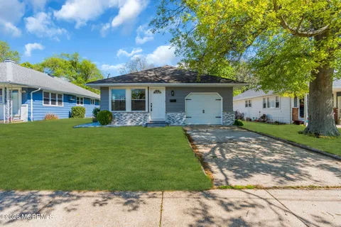 a front view of house with a garden and patio