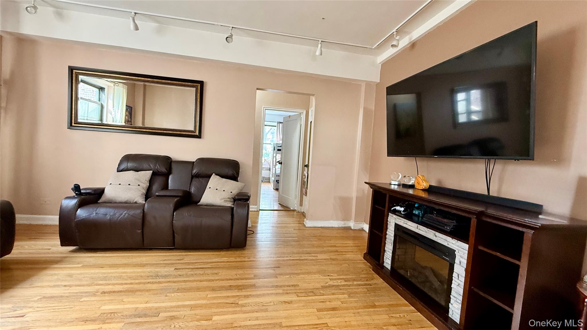 112-25 34th Avenue, Unit G Queens, NY 11368 - Photo 11 of 47 a living room with furniture and a flat screen tv