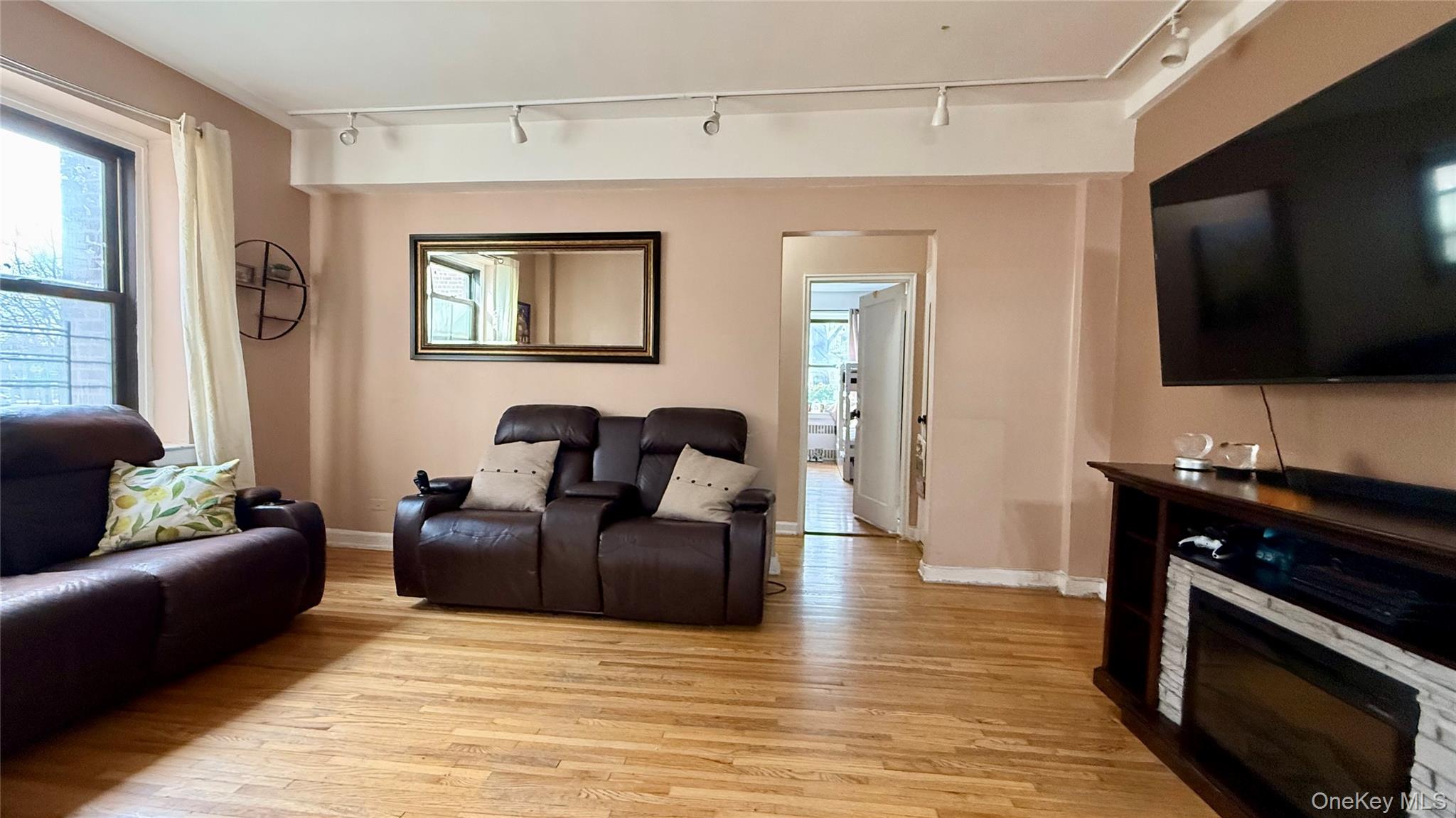 112-25 34th Avenue, Unit G Queens, NY 11368 - Photo 13 of 47 a living room with furniture and a flat screen tv