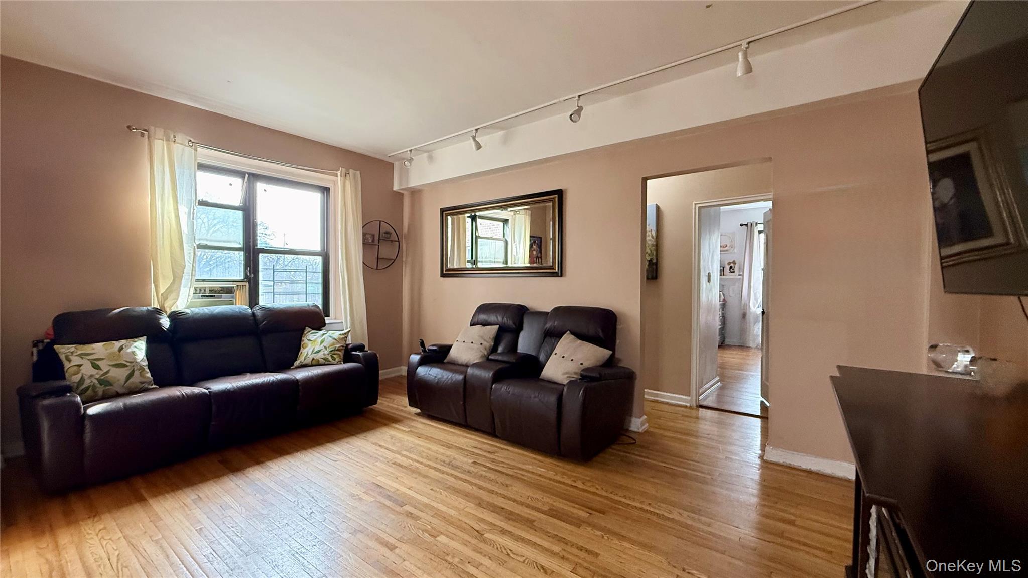 112-25 34th Avenue, Unit G Queens, NY 11368 - Photo 14 of 47 a living room with furniture and a window