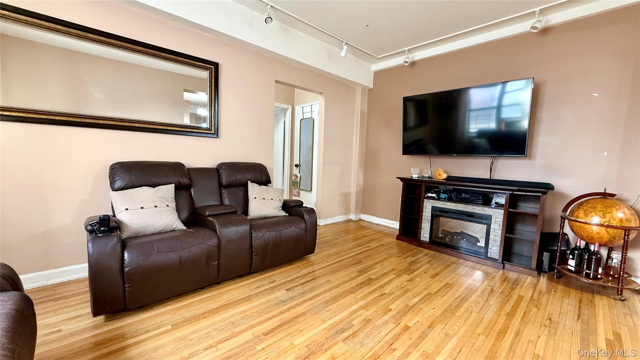 112-25 34th Avenue, Unit G Queens, NY 11368 - Photo 15 of 47 a living room with furniture and a flat screen tv