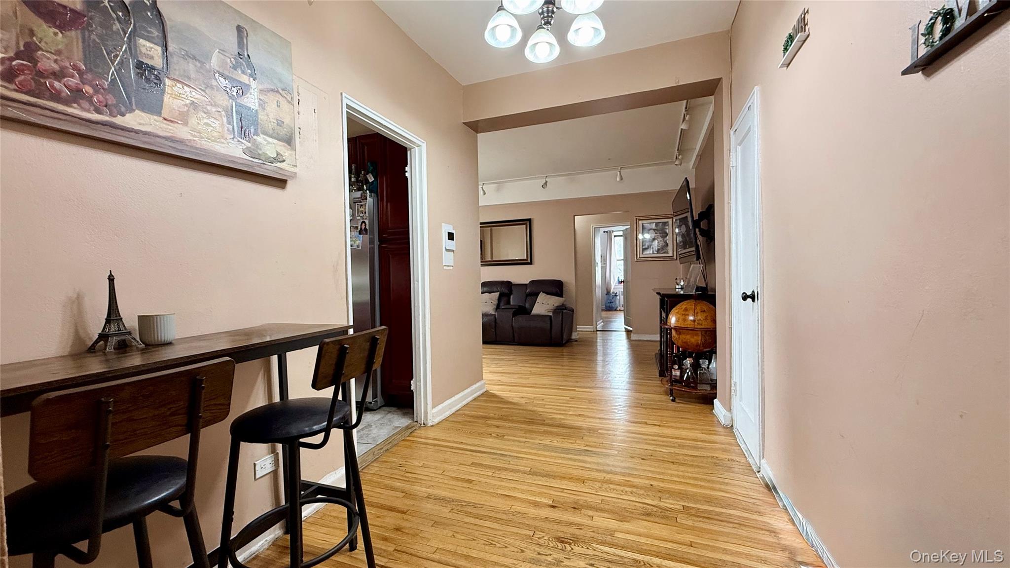 112-25 34th Avenue, Unit G Queens, NY 11368 - Photo 2 of 47 a view of a hallway to a livingroom and a dinning room with furniture