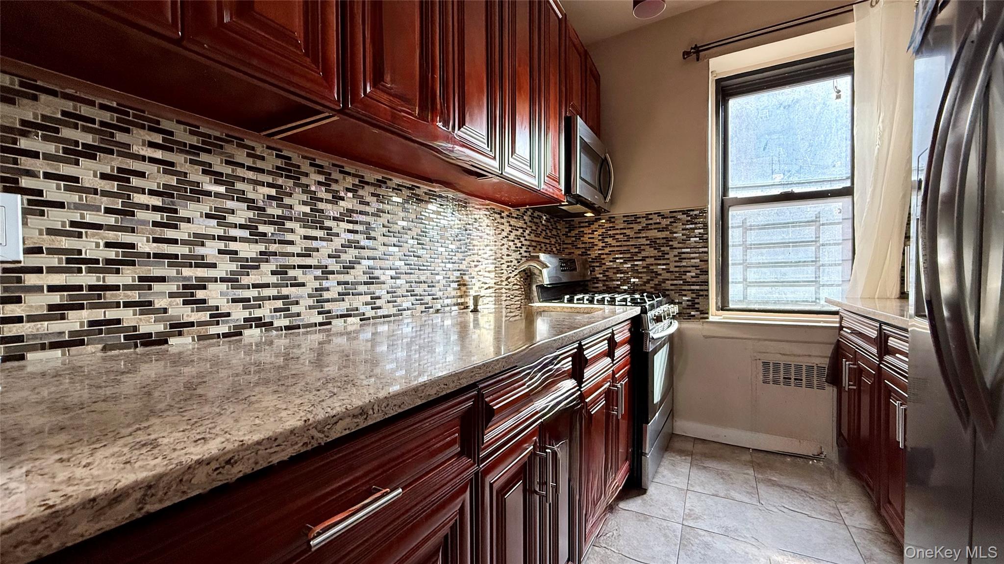 112-25 34th Avenue, Unit G Queens, NY 11368 - Photo 21 of 47 a kitchen with a sink and cabinets