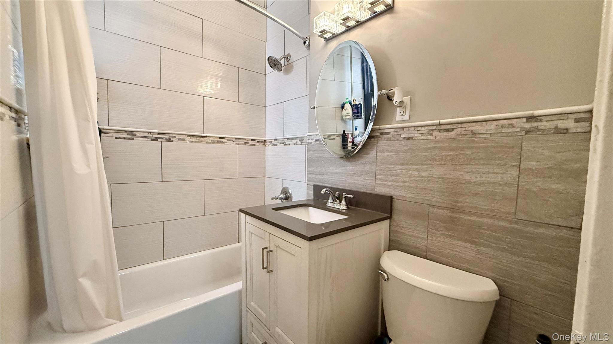 112-25 34th Avenue, Unit G Queens, NY 11368 - Photo 24 of 47 a bathroom with a sink a toilet and shower