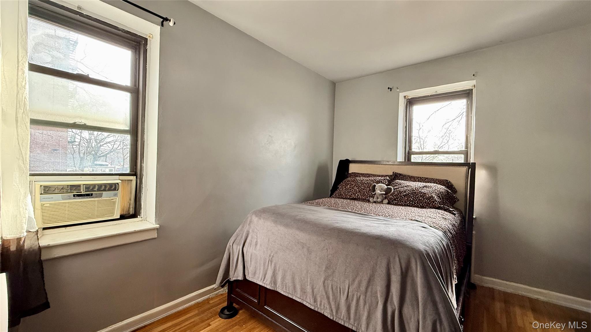 112-25 34th Avenue, Unit G Queens, NY 11368 - Photo 27 of 47 a bedroom with a bed and a window