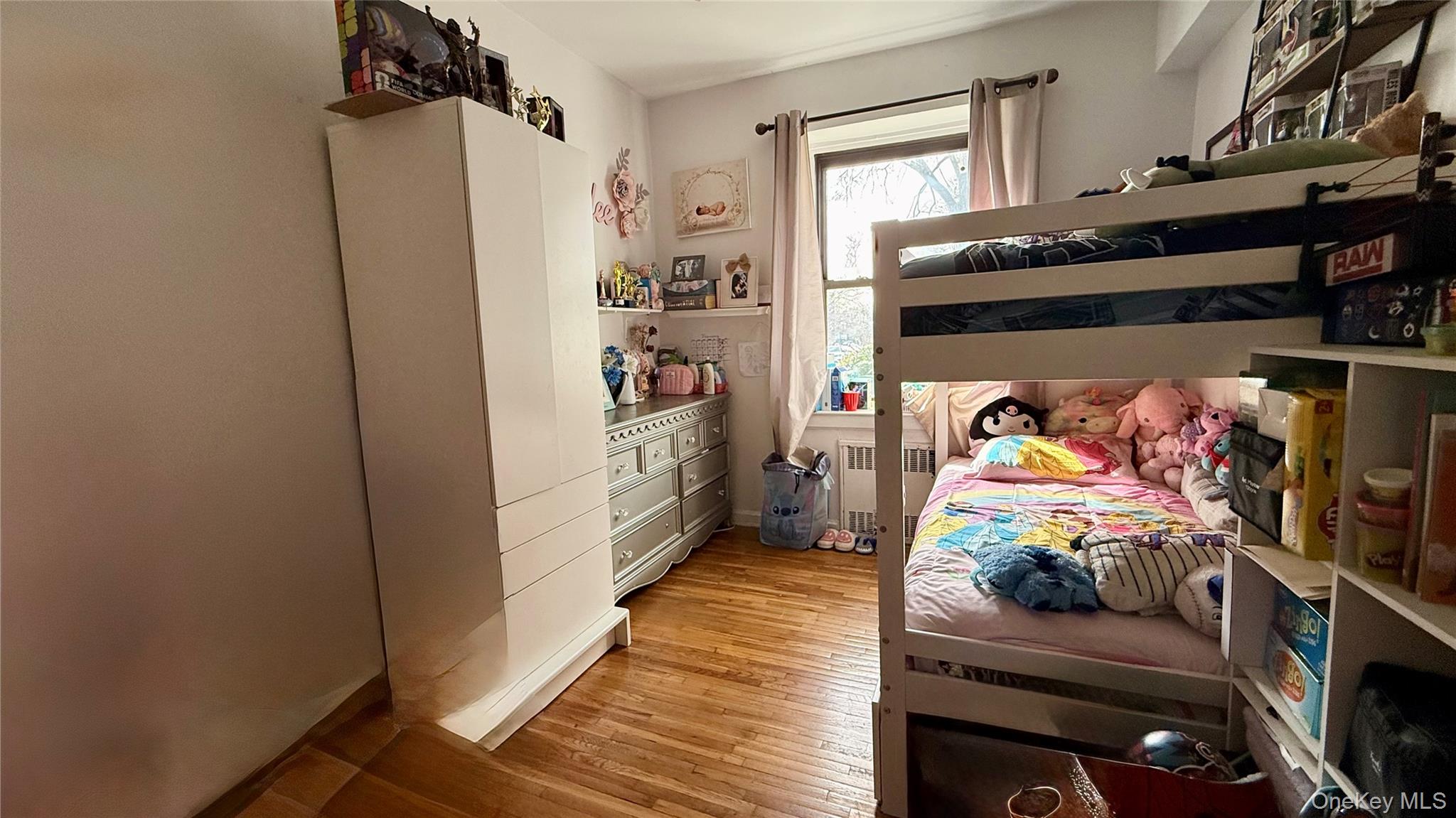 112-25 34th Avenue, Unit G Queens, NY 11368 - Photo 28 of 47 a bed room with a bed and a window