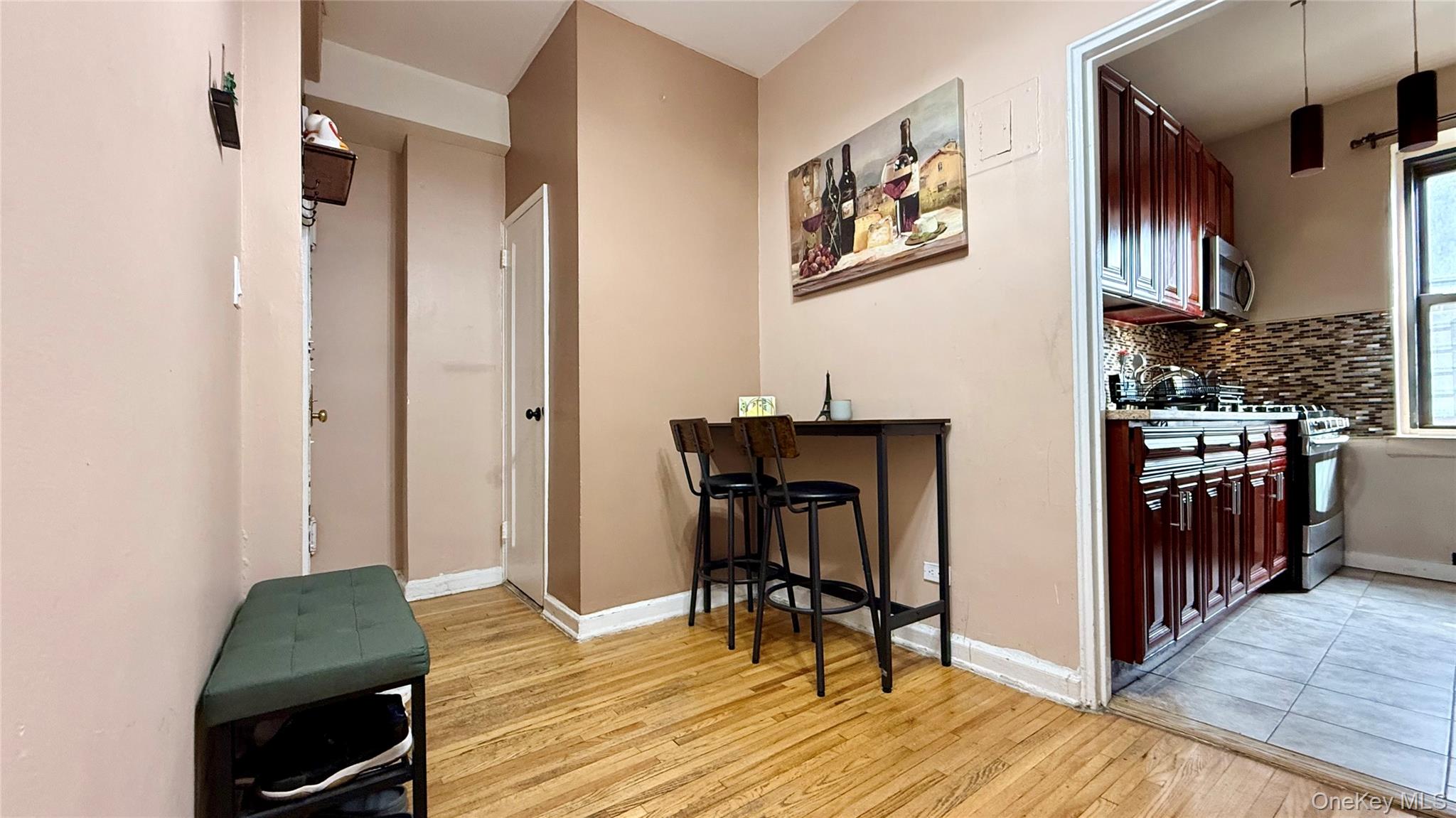 112-25 34th Avenue, Unit G Queens, NY 11368 - Photo 3 of 47 a view of a hallway with wooden floor and furniture