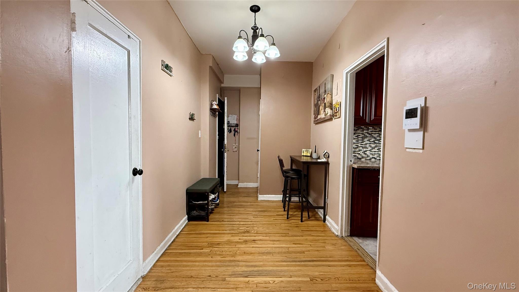 112-25 34th Avenue, Unit G Queens, NY 11368 - Photo 8 of 47 a very nice looking room with a mirror and a wooden floor