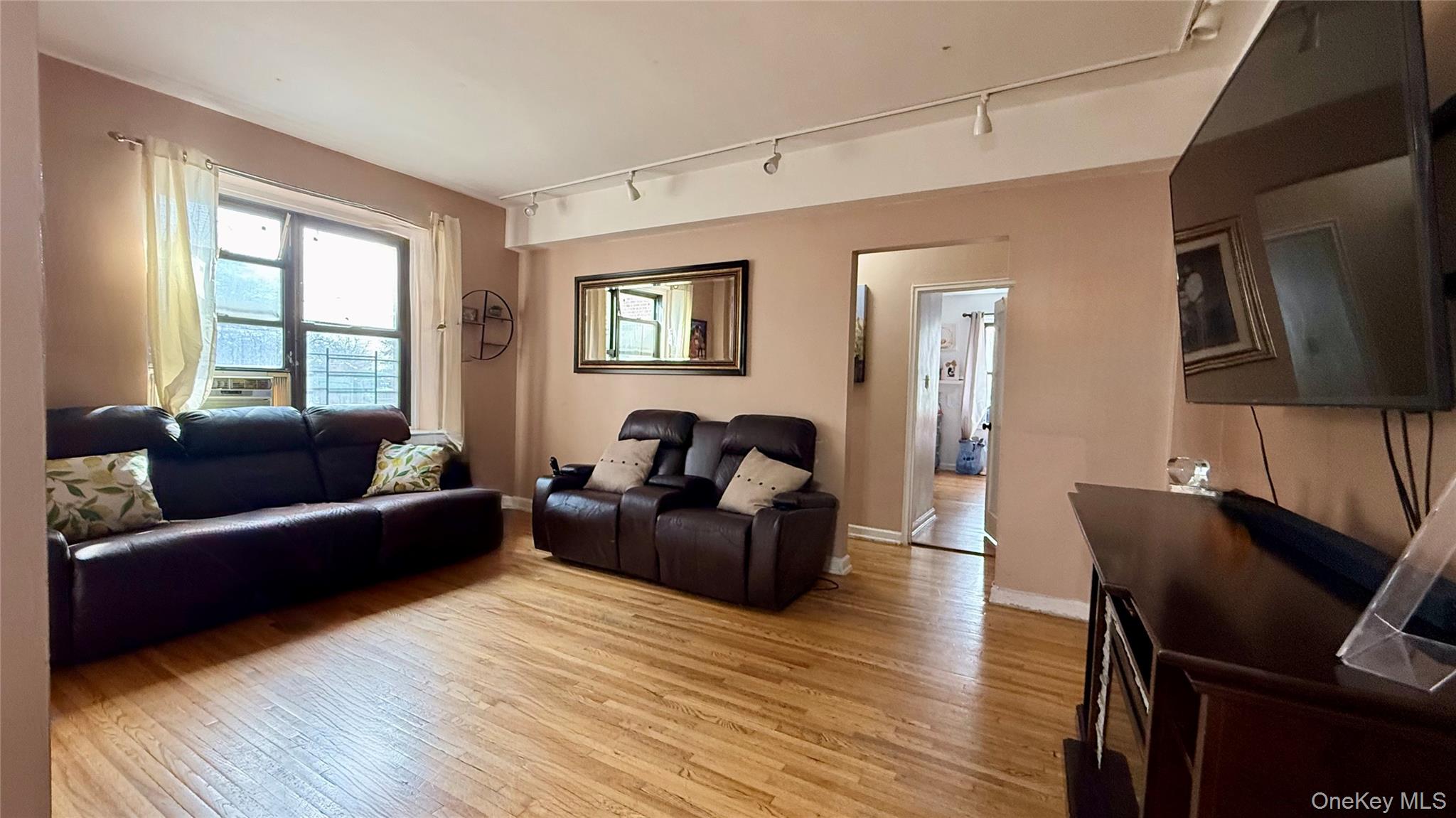 112-25 34th Avenue, Unit G Queens, NY 11368 - Photo 9 of 47 a living room with furniture and a flat screen tv