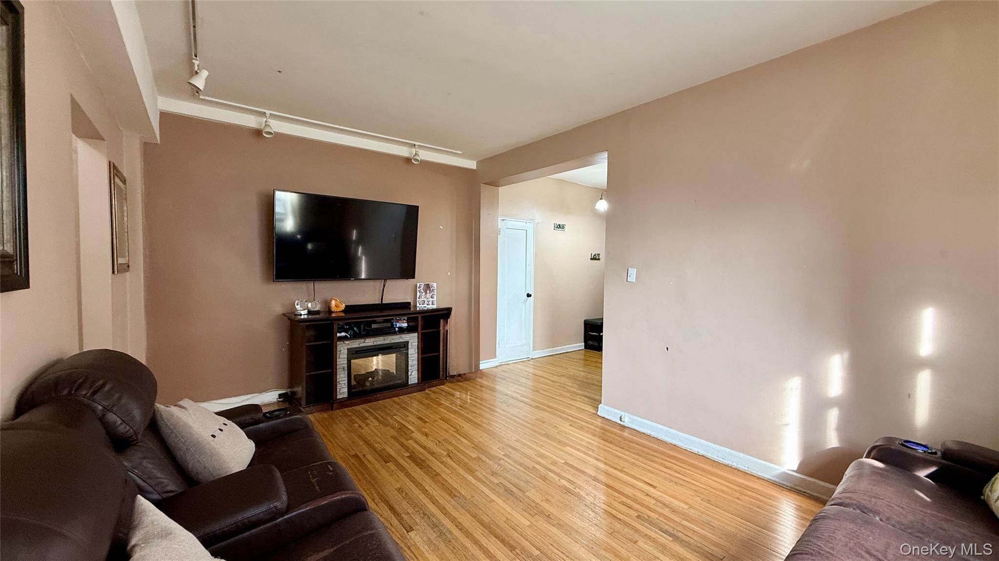 112-25 34th Avenue, Unit G Queens, NY 11368 - Photo 10 of 47 a view of a livingroom with furniture and a flat screen tv