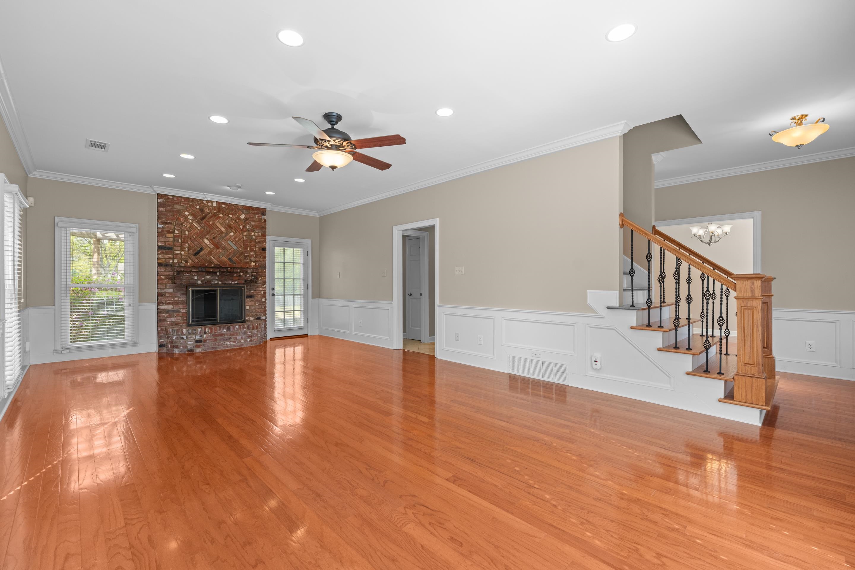 677 Gunnison Cove Collierville, TN 38017 - Photo 11 of 30 a view of an empty room with wooden floor fireplace and a window
