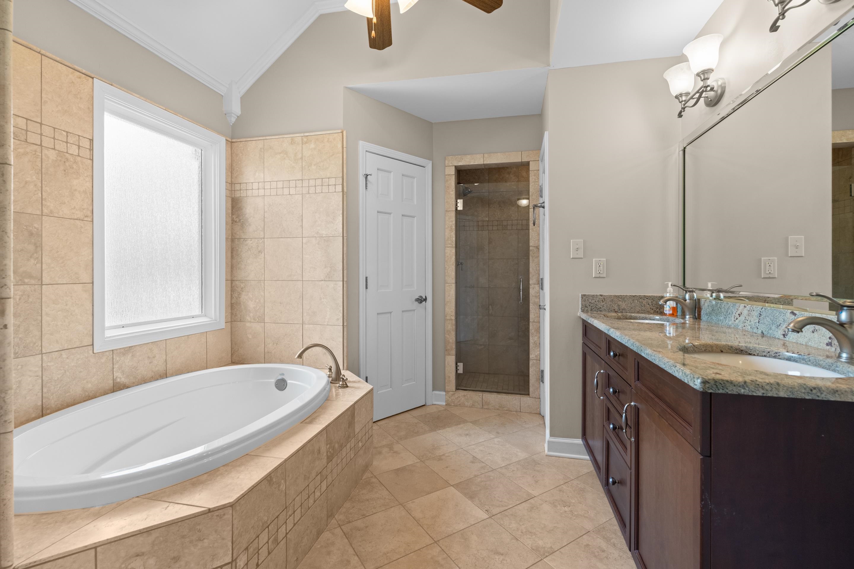 677 Gunnison Cove Collierville, TN 38017 - Photo 13 of 30 a bathroom with a tub sink and mirror