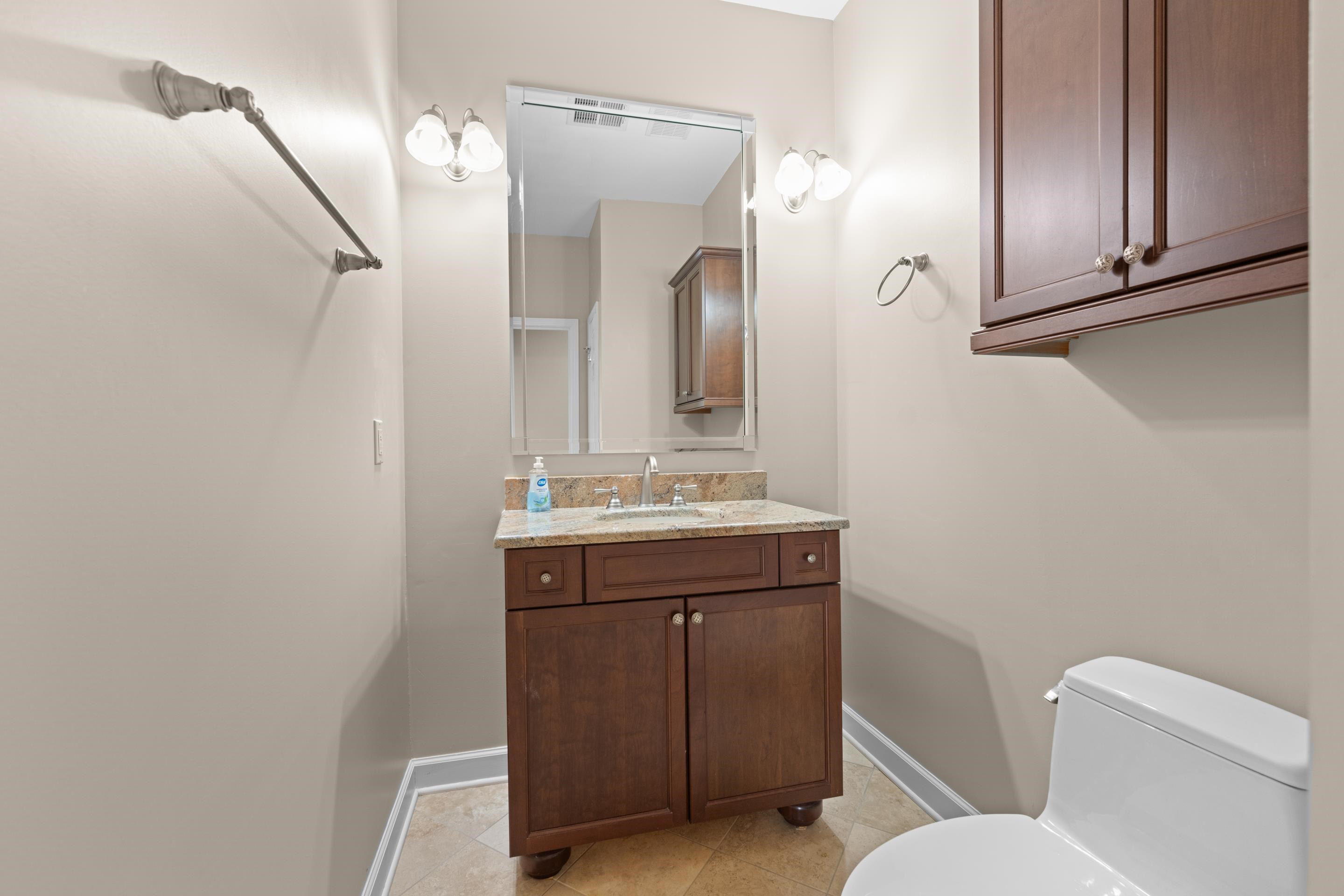 677 Gunnison Cove Collierville, TN 38017 - Photo 22 of 30 a bathroom with a toilet a sink and mirror