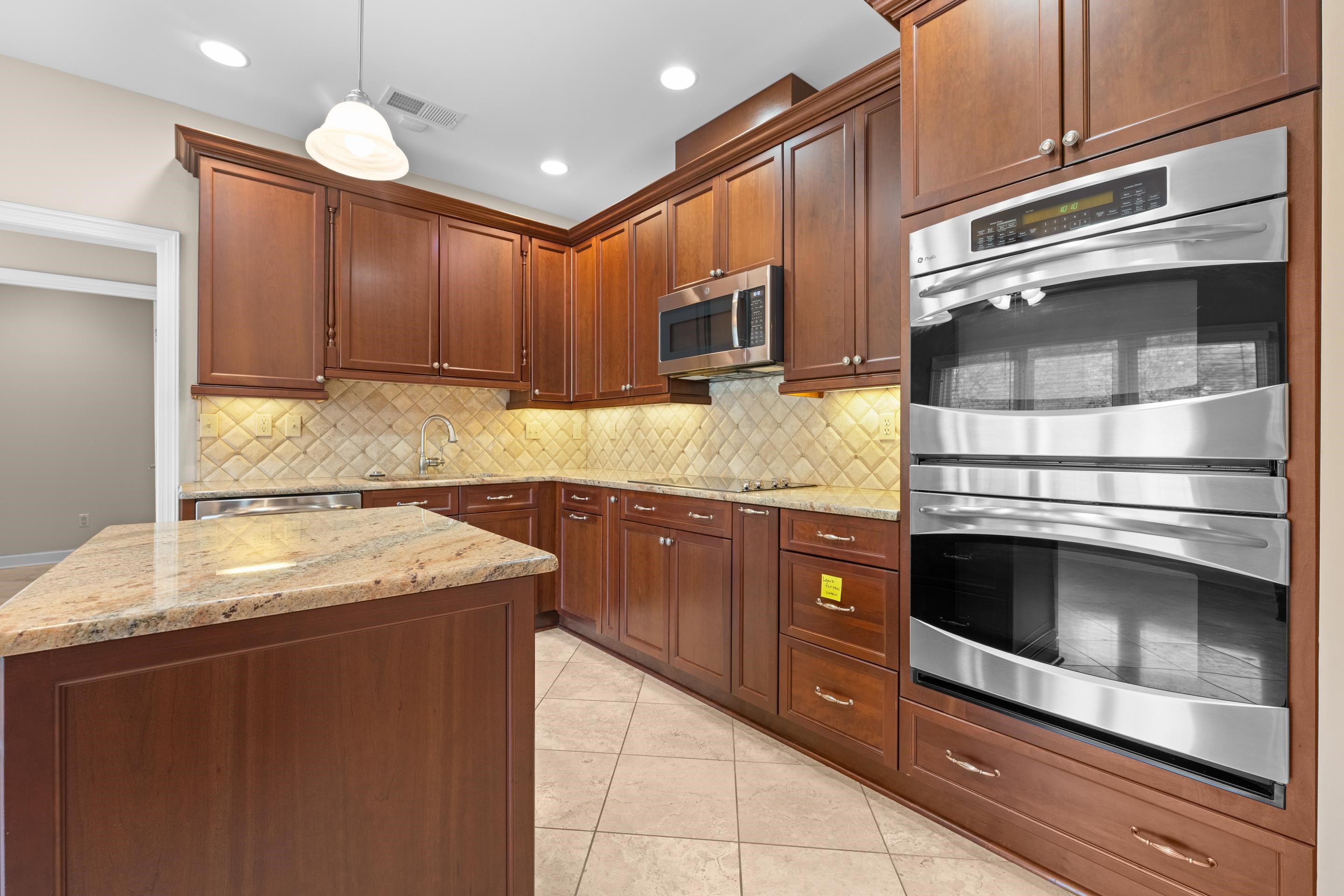 677 Gunnison Cove Collierville, TN 38017 - Photo 6 of 30 a kitchen with stainless steel appliances granite countertop a stove and a microwave