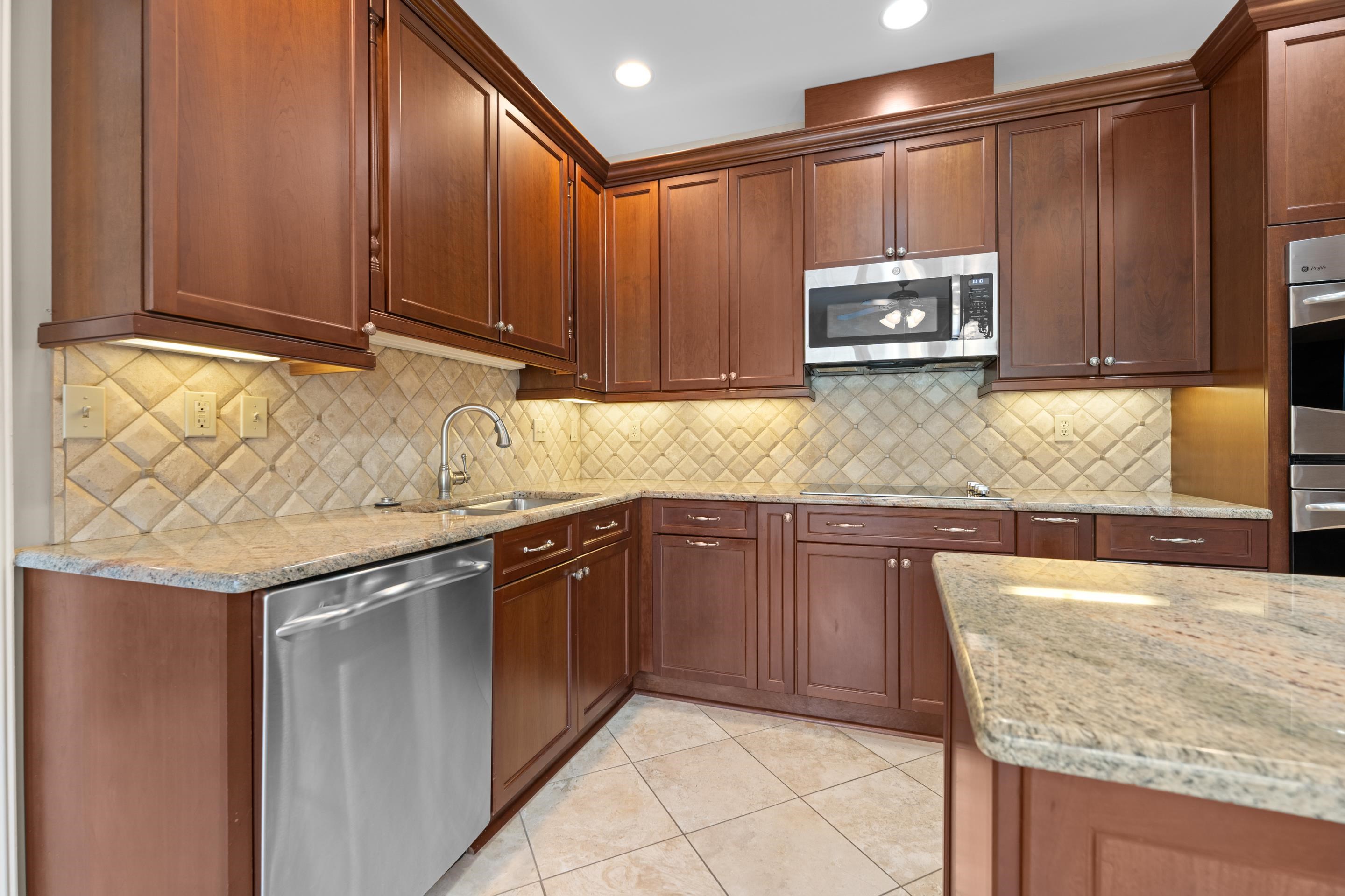 677 Gunnison Cove Collierville, TN 38017 - Photo 7 of 30 a kitchen with stainless steel appliances granite countertop a sink and cabinets