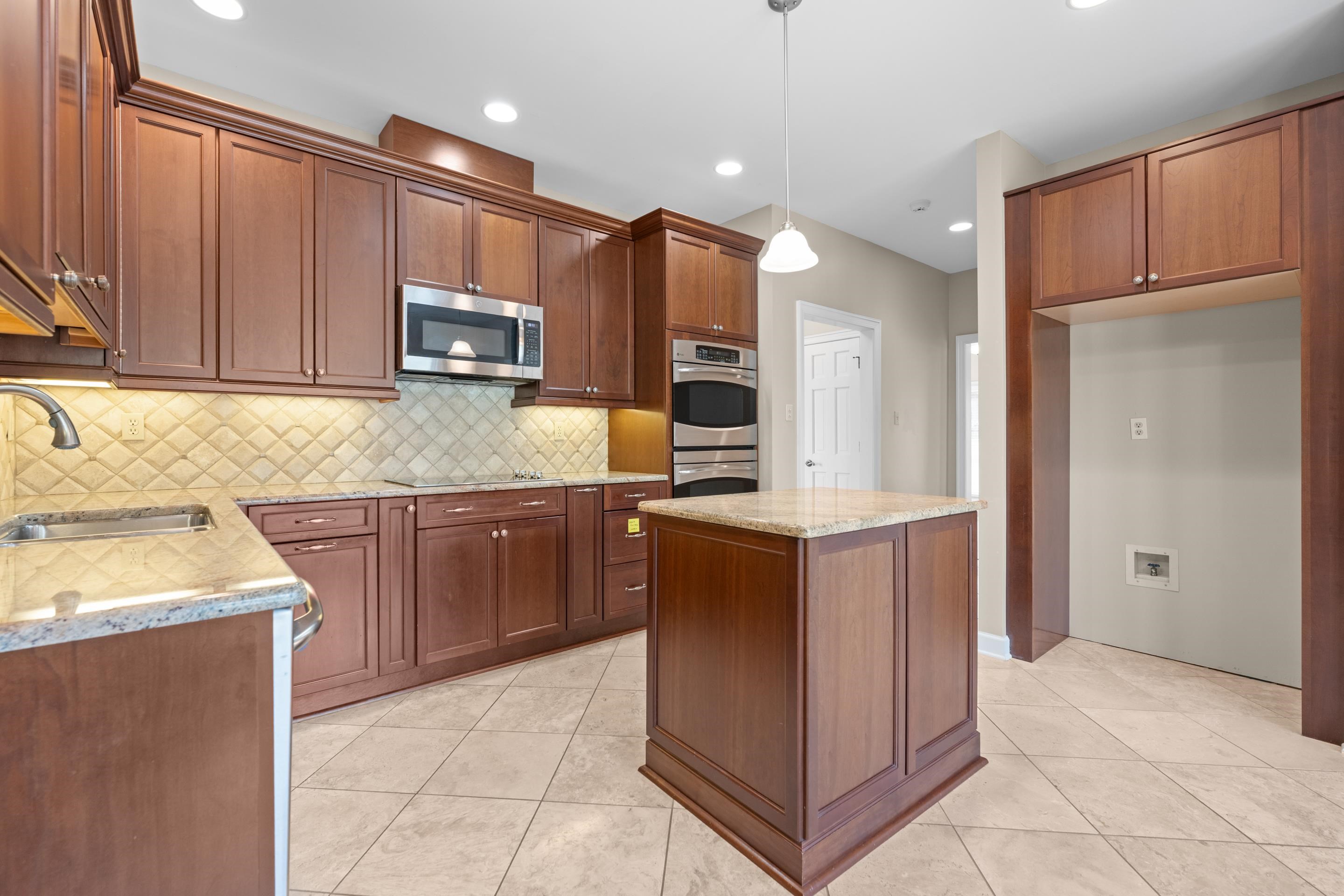 677 Gunnison Cove Collierville, TN 38017 - Photo 8 of 30 a kitchen with stainless steel appliances granite countertop a refrigerator oven a sink and dishwasher