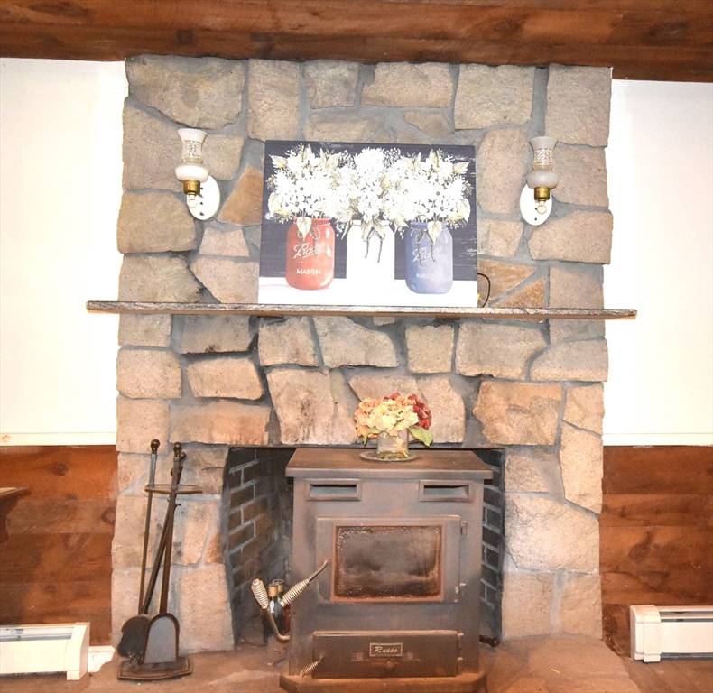 648 Walnut Plain Road Rochester, MA 02770 - Photo 13 of 21 a kitchen with a stove and white cabinets