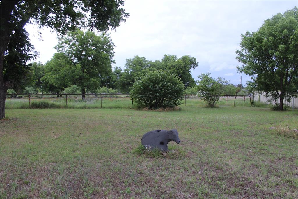 510 Hamby Road Clyde, TX 79510 - Photo 6 of 23 Expansive grassy yard featuring mature trees and a perimeter fence