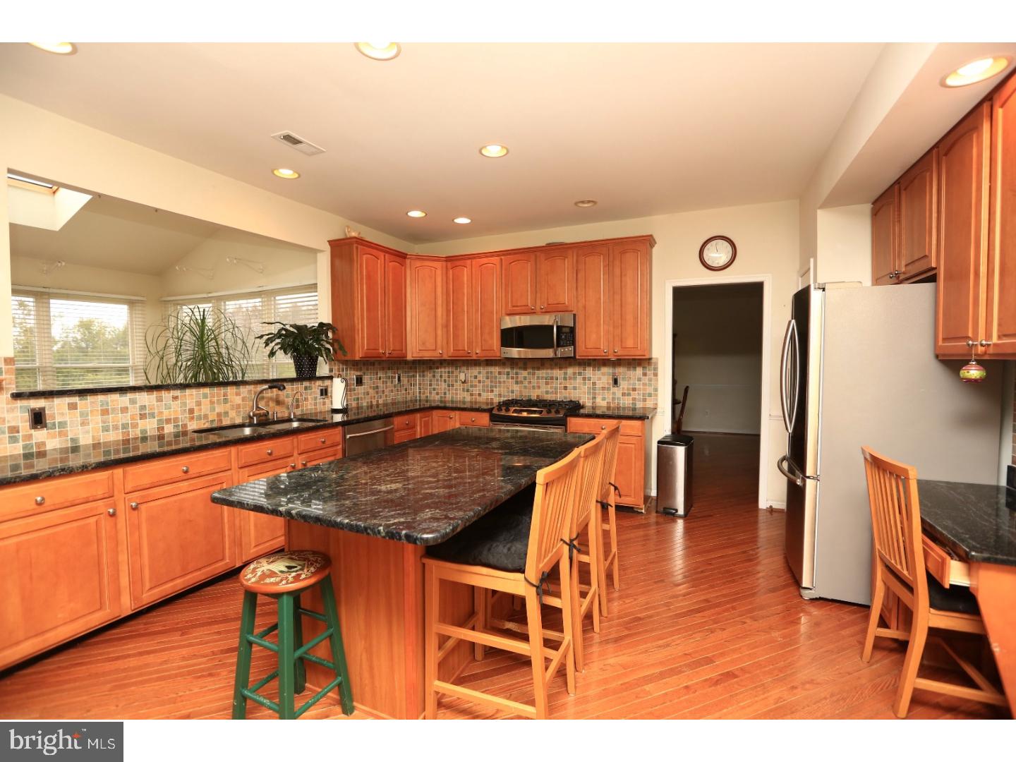 99 Hope Road Southampton, PA 18966 - Photo 8 of 17 a kitchen with stainless steel appliances granite countertop a refrigerator a stove a sink a dining table and chairs