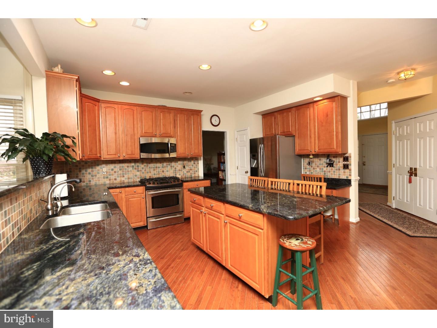 99 Hope Road Southampton, PA 18966 - Photo 9 of 17 a kitchen with stainless steel appliances granite countertop a stove top oven a sink dishwasher and cabinets with wooden floor