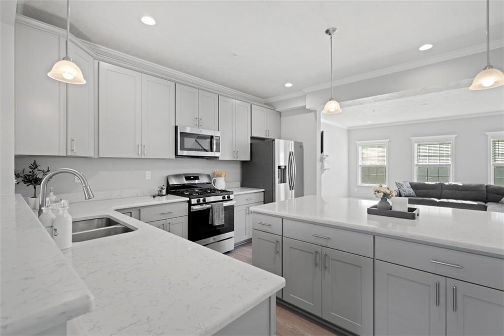 209 Lockheed Drive Coraopolis, PA 15108 - Photo 15 of 38 a kitchen with kitchen island a sink appliances and cabinets