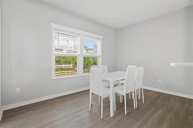 a dining room with furniture and wooden floor