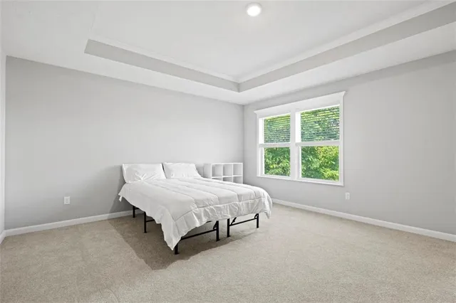 a bed sitting in a bedroom next to a window