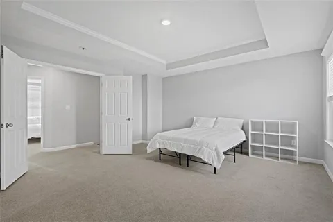 a spacious bedroom with a bed and a window