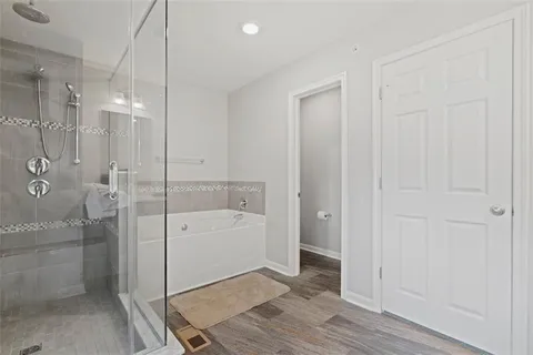a bathroom with a bathtub and shower
