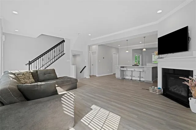 a living room with furniture fireplace and flat screen tv