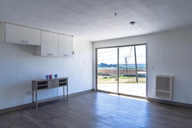 a living room with hard wood floors and a window