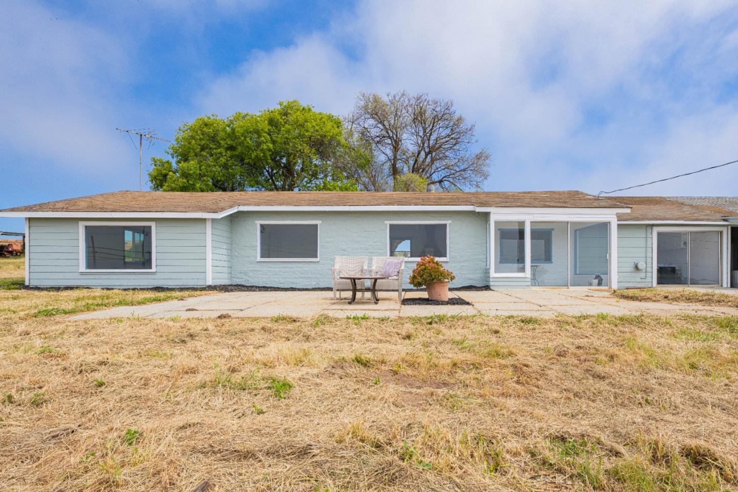 706 San Andreas Road Watsonville, CA 95076 - Photo 18 of 26 a backyard of a house with table and chairs and wooden fence