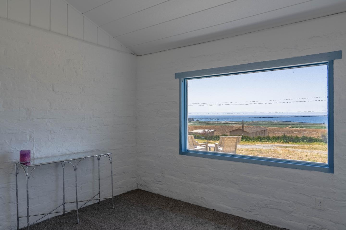 706 San Andreas Road Watsonville, CA 95076 - Photo 22 of 26 a view of an empty room with wooden floor and a window
