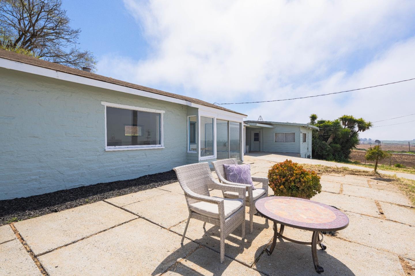 706 San Andreas Road Watsonville, CA 95076 - Photo 23 of 26 a balcony with table and chairs and potted plants