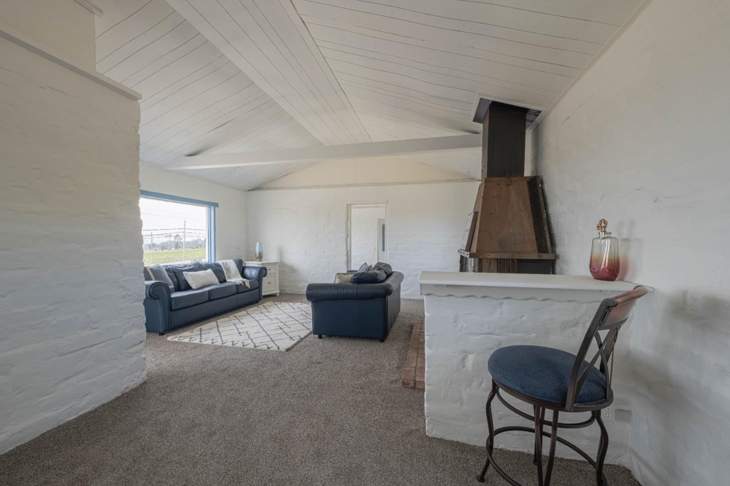 706 San Andreas Road Watsonville, CA 95076 - Photo 7 of 26 a living room with furniture and a fireplace