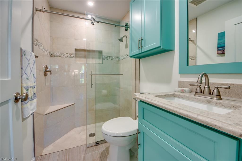 16541 Bayleaf Lane, Unit 56 Fort Myers, FL 33908 - Photo 12 of 24 a bathroom with a granite countertop sink toilet and shower