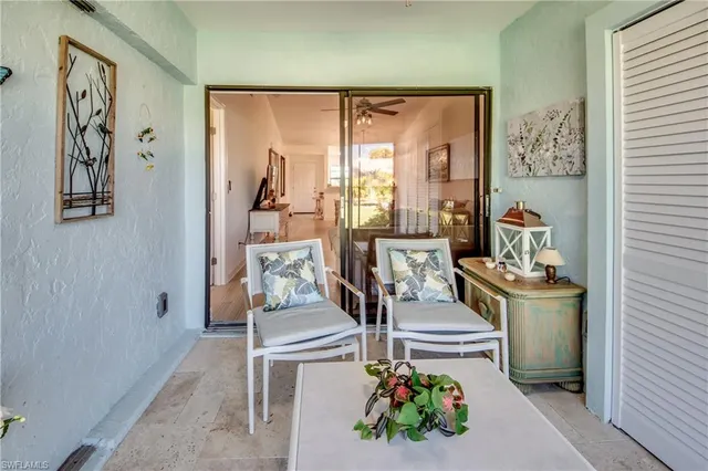 a living room with a couch and a potted plant