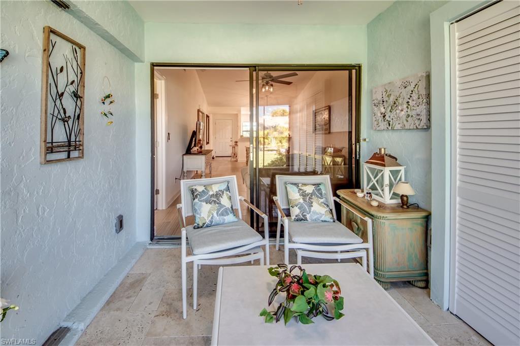 16541 Bayleaf Lane, Unit 56 Fort Myers, FL 33908 - Photo 13 of 24 a living room with a couch and a potted plant
