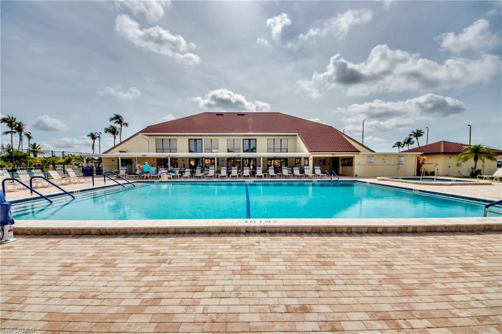 16541 Bayleaf Lane, Unit 56 Fort Myers, FL 33908 - Photo 17 of 24 a view of a lake with a house in the background