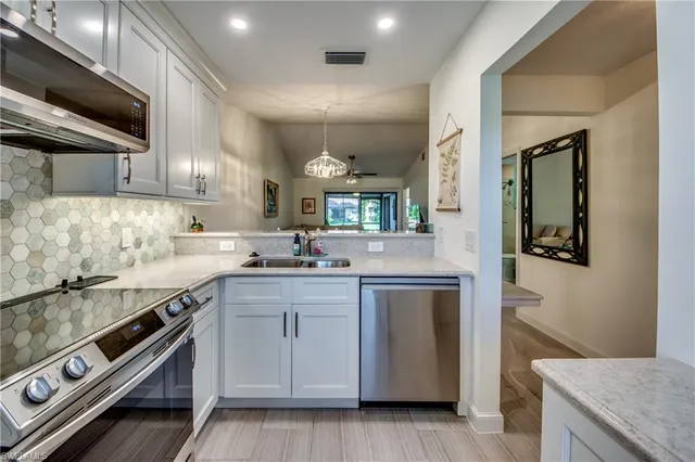 a kitchen with a sink stove and cabinets