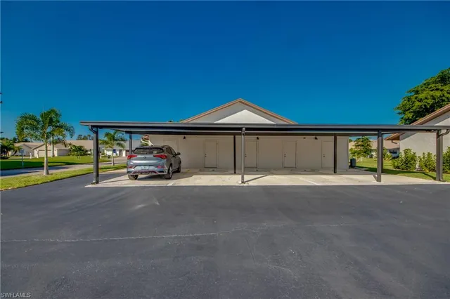 a car parked in front of a house with a yard