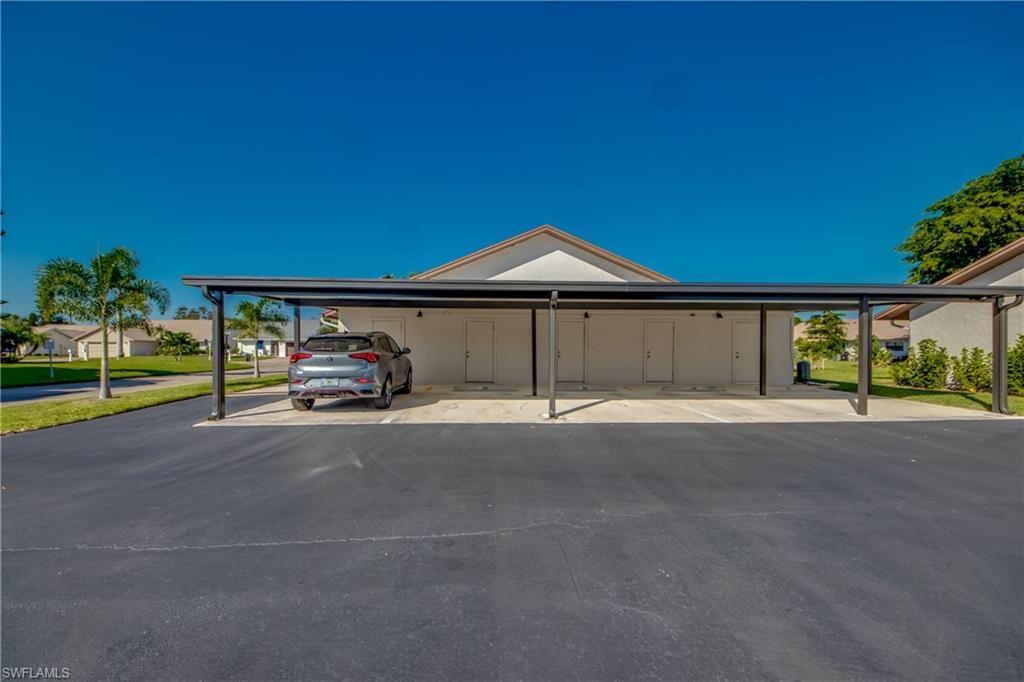 16541 Bayleaf Lane, Unit 56 Fort Myers, FL 33908 - Photo 21 of 24 a car parked in front of a house with a yard