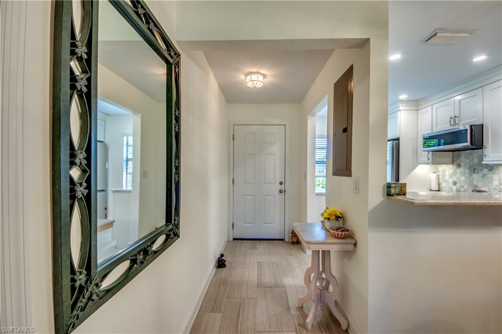 16541 Bayleaf Lane, Unit 56 Fort Myers, FL 33908 - Photo 5 of 24 a view of living room with furniture and a chandelier