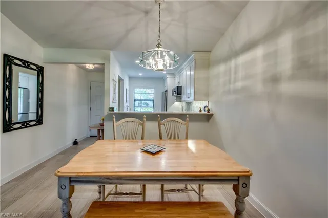 a view of a dining room with furniture and a chandelier