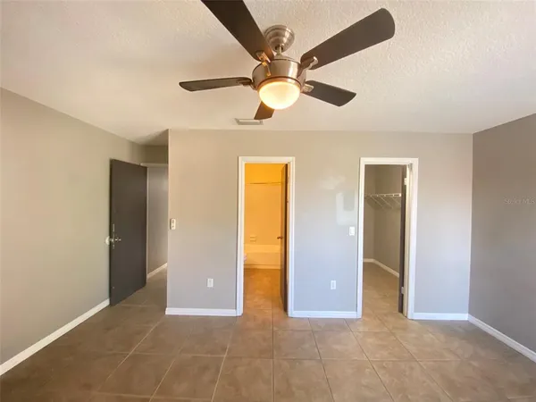 a view of a livingroom with a ceiling fan and window