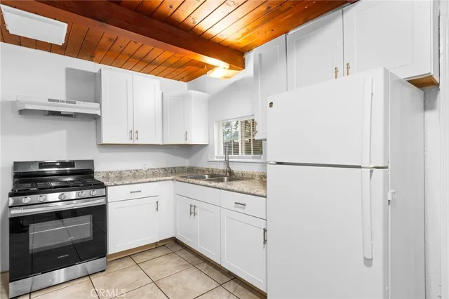 a kitchen with stainless steel appliances a refrigerator sink and cabinets