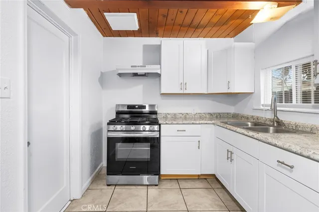 a kitchen with cabinets appliances and a window